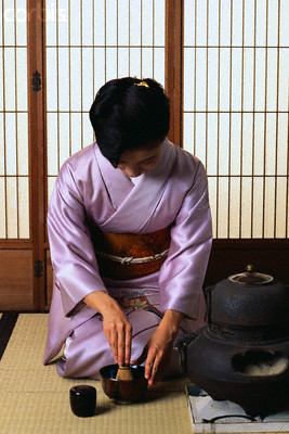 Japanese woman performing tea ceremony in seiza sitting position